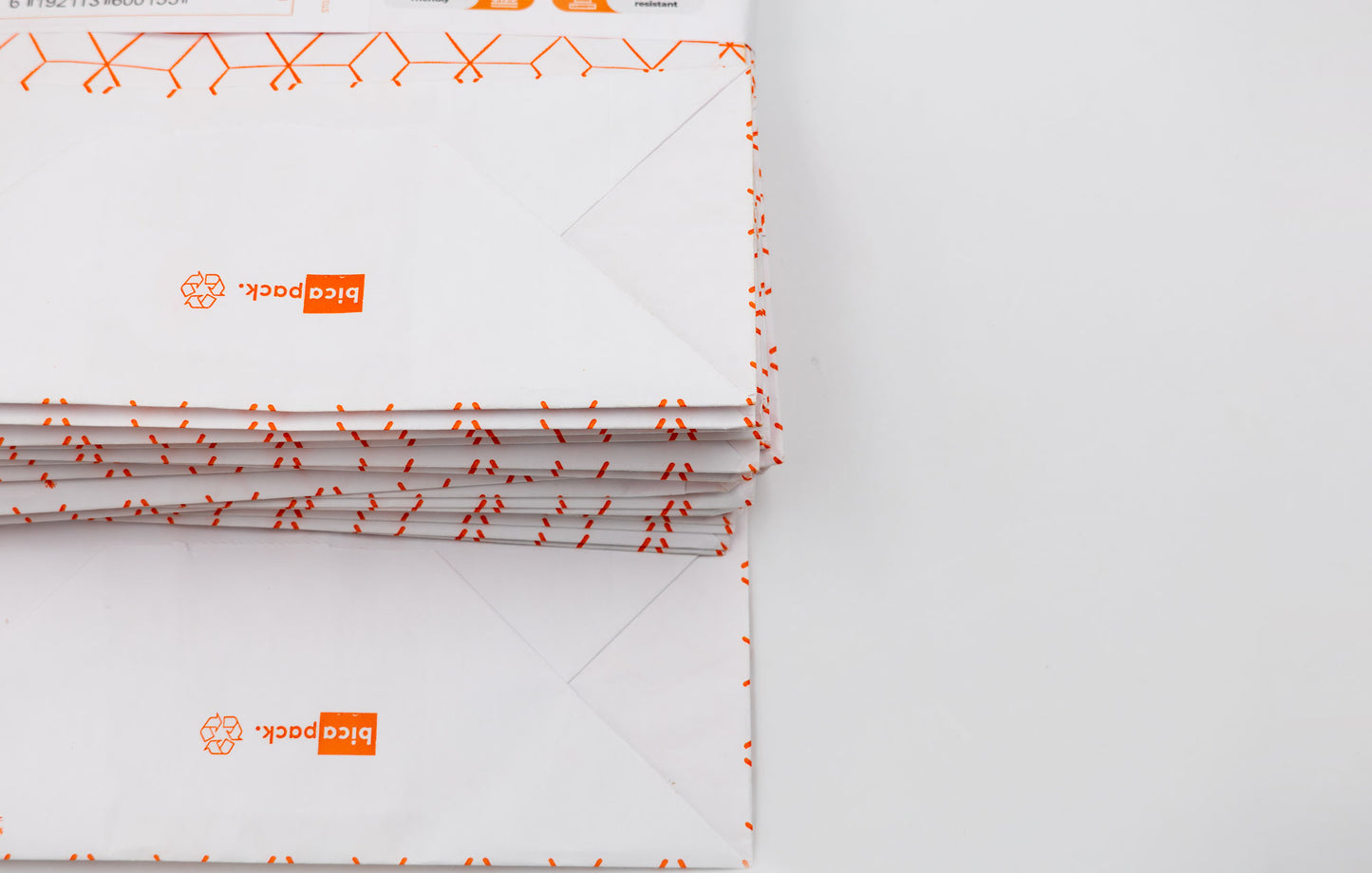 Pack de 25 Bolsas de Papel Kraft Reciclado con Asas Trenzadas y Estampado Geométrico en Naranja