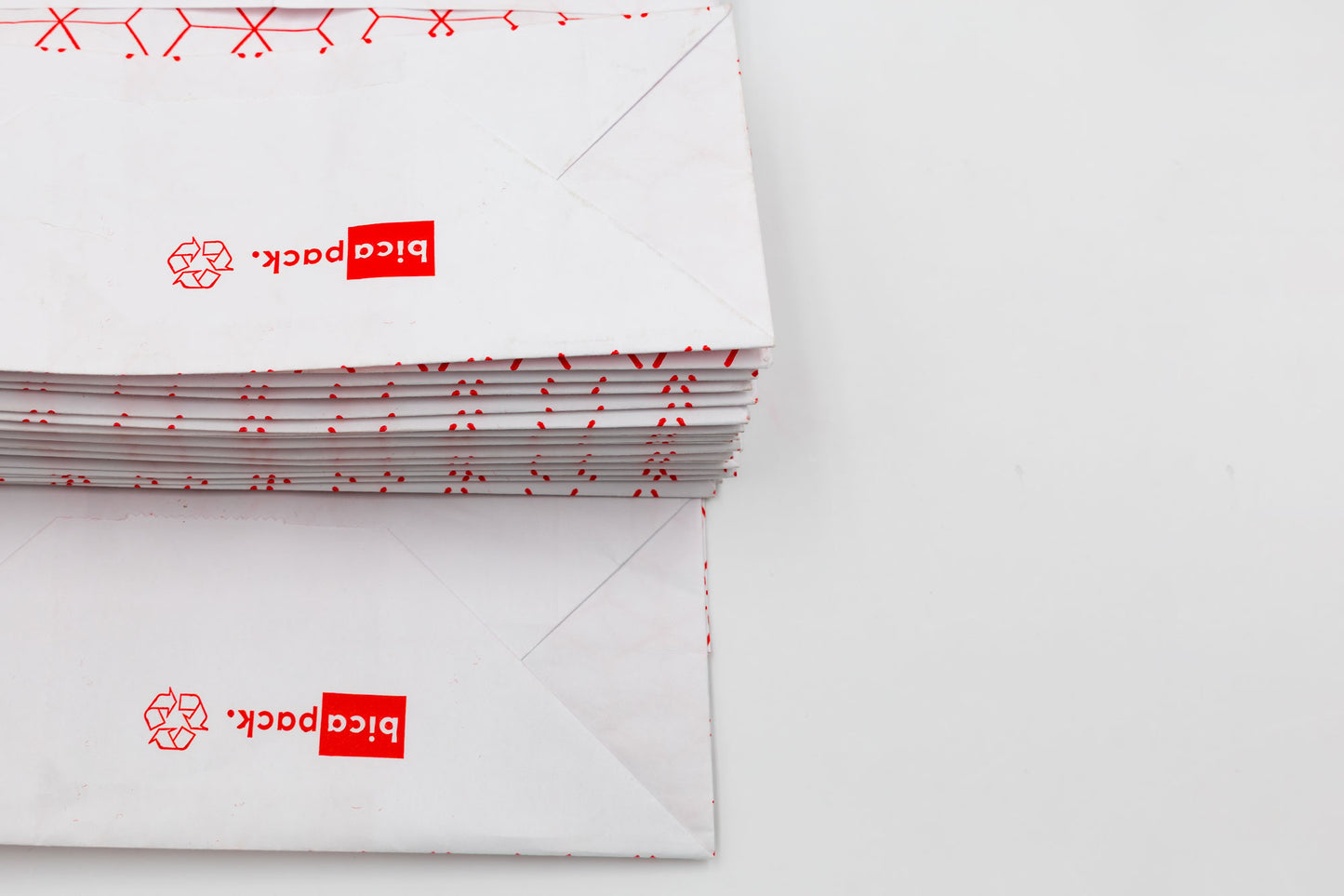 Pack de 25 Bolsas de Papel Kraft Reciclado con Asas Trenzadas y Estampado Geométrico en Rojo